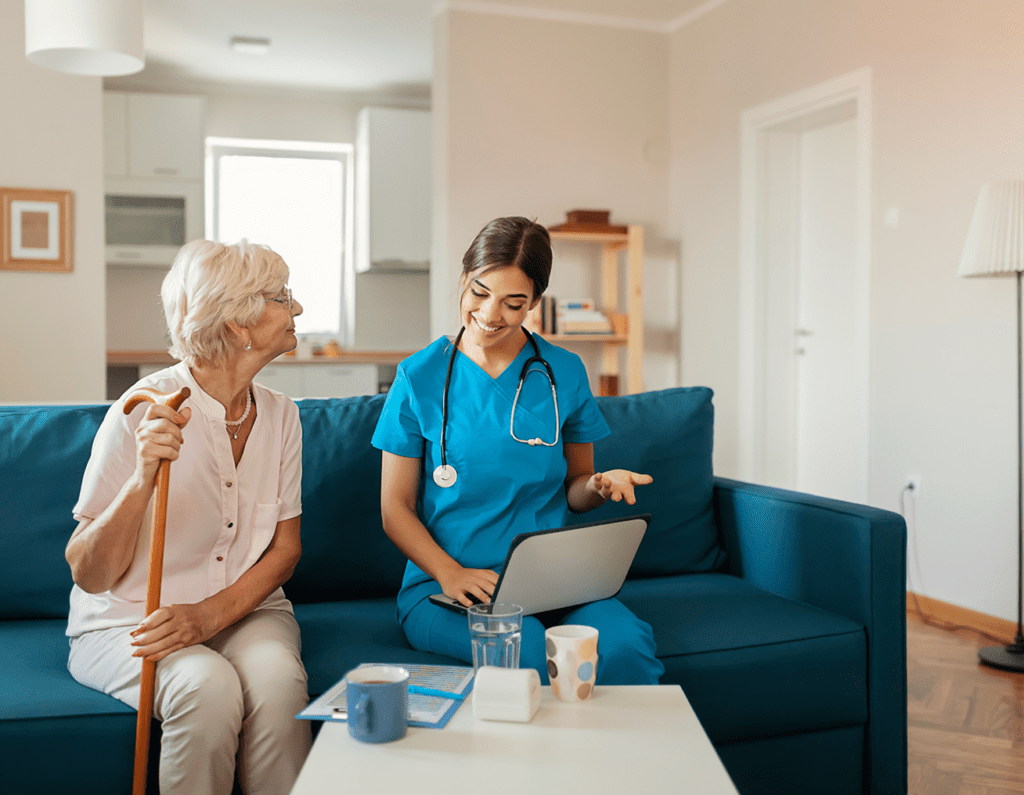 Nurse discussing health information with elderly woman at home.