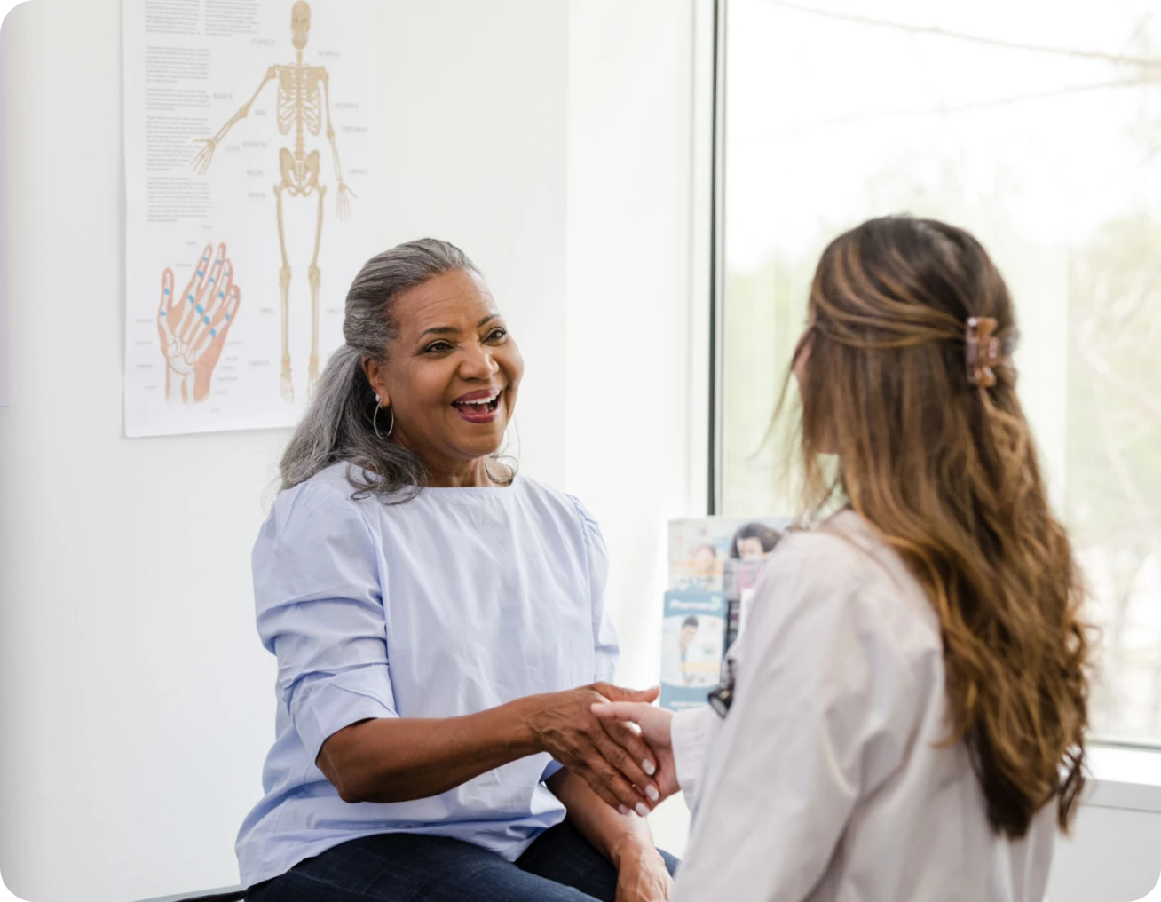 Woman shaking hands with a doctor.